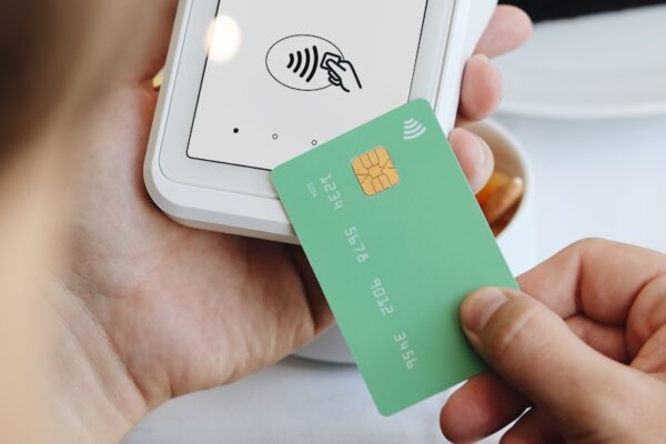 A person holding a credit card in their hand