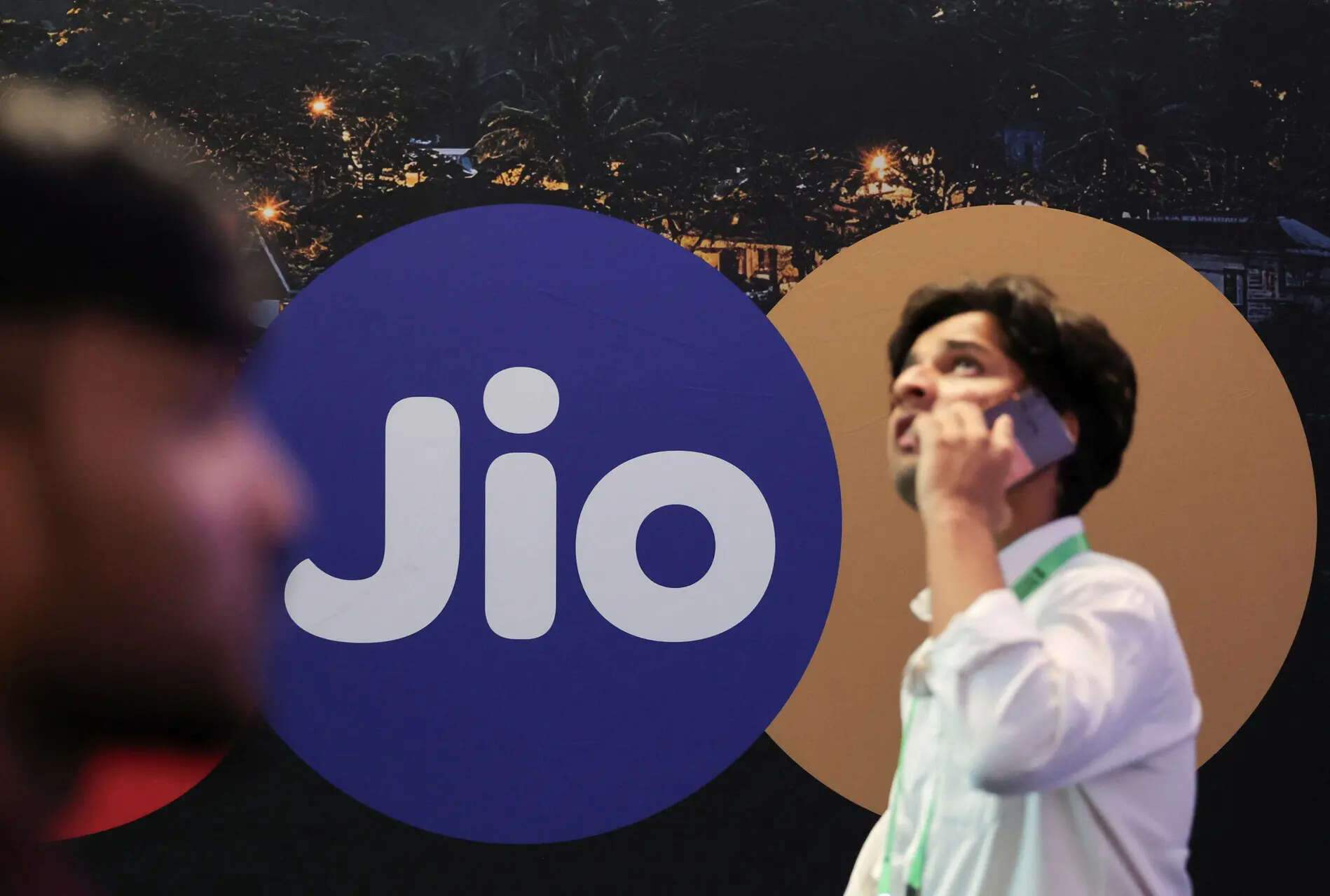 <p>People walk past a panel showing the logo of Jio at the ongoing India Mobile Congress 2025 at Yashobhoomi, a convention and expo center in New Delhi, India, October 8, 2025. REUTERS/Anushree Fadnavis</p>
